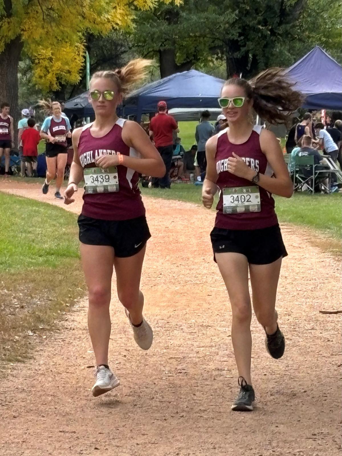 Two girls running cross country