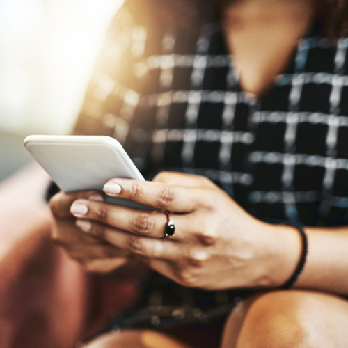 Photo of a person holding their cell phone