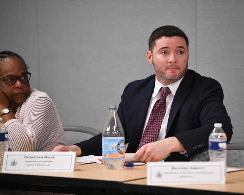 Deputy Secretary Miele listens at meeting. 