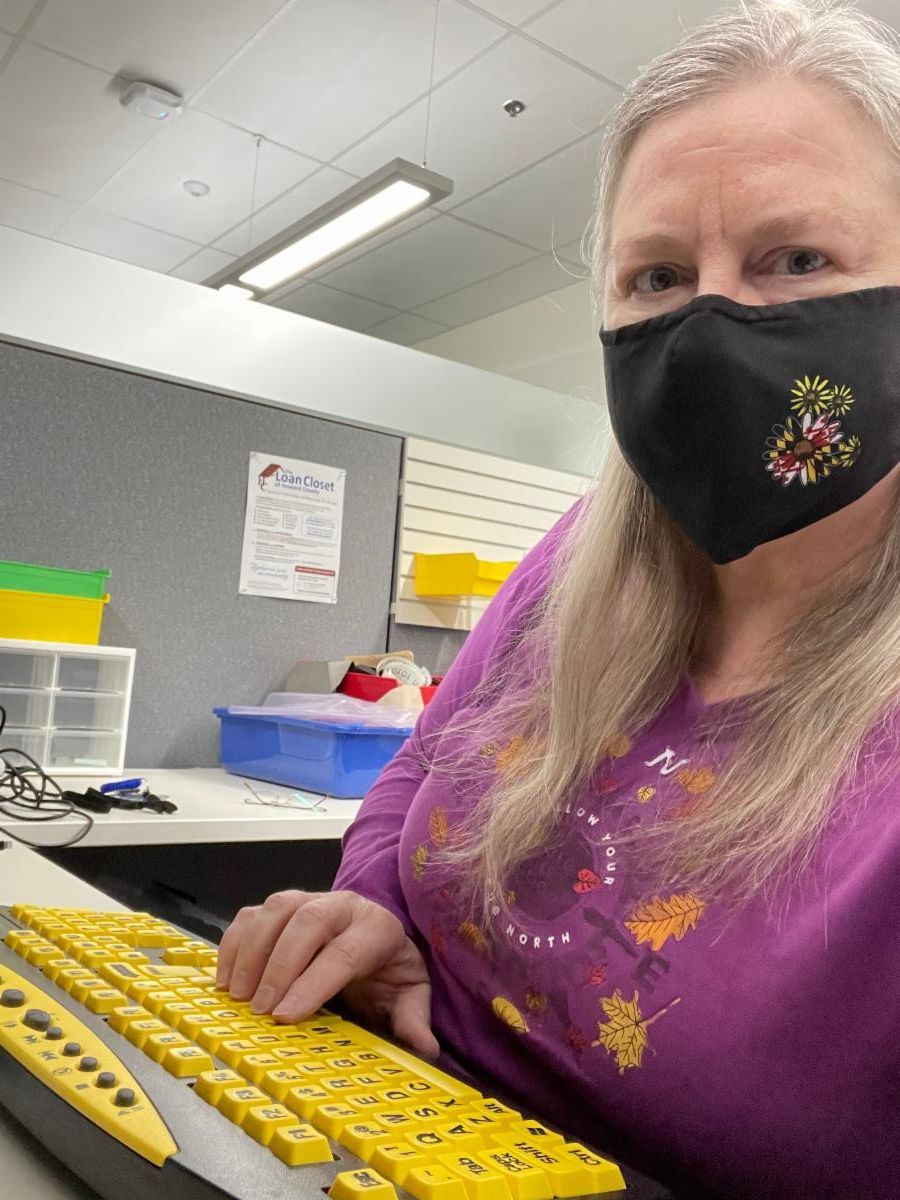 Woman shown using an adaptive keyboard with enlarged keys that have sharp contrast. 