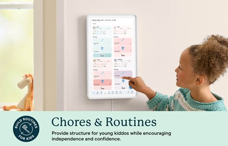 A young girl using the touchscreen to highlight a chore