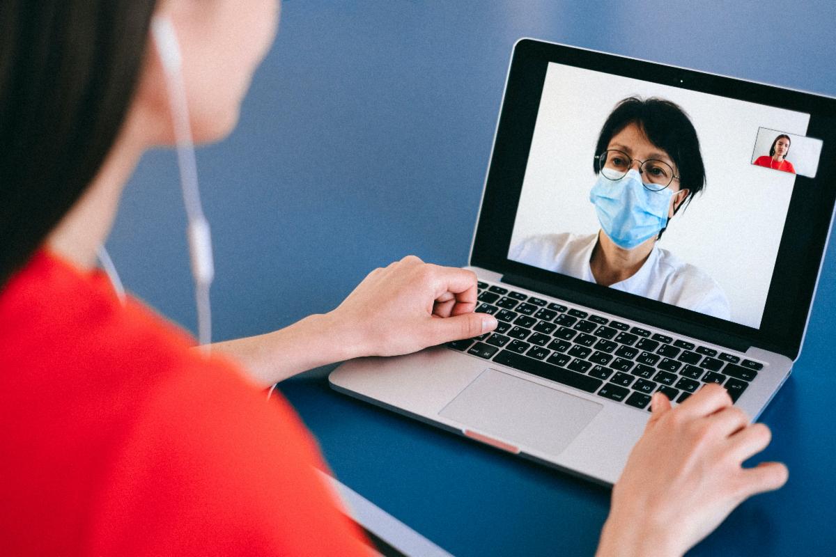 Woman using laptop to meet with doctor