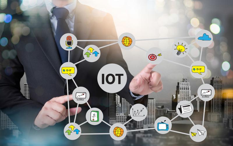 IOT business man hand working and internet of things  IoT  word diagram as concept and businessman working with modern technology