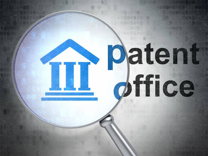 Law concept  magnifying optical glass with Courthouse icon and Patent Office word on digital background