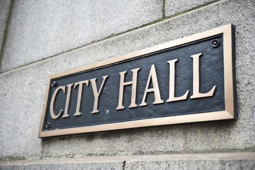 A blue colored plaque mentioning City Hall attached to the wall of the Chicago City Hall and County Building in Chicago_ Illinois. It is one of the oldest buildings in the city.