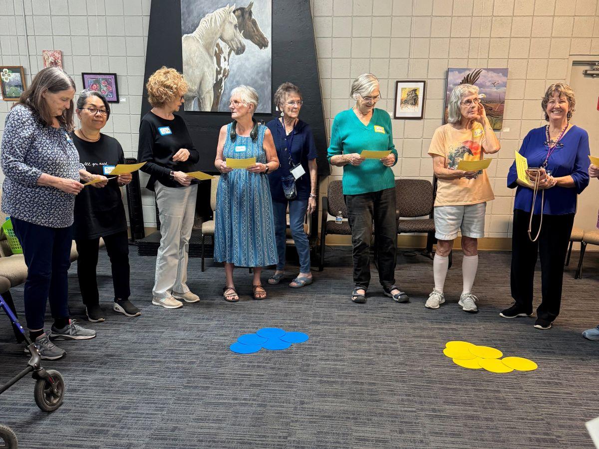 Donna Knorton and other OLLI members preparing to sing