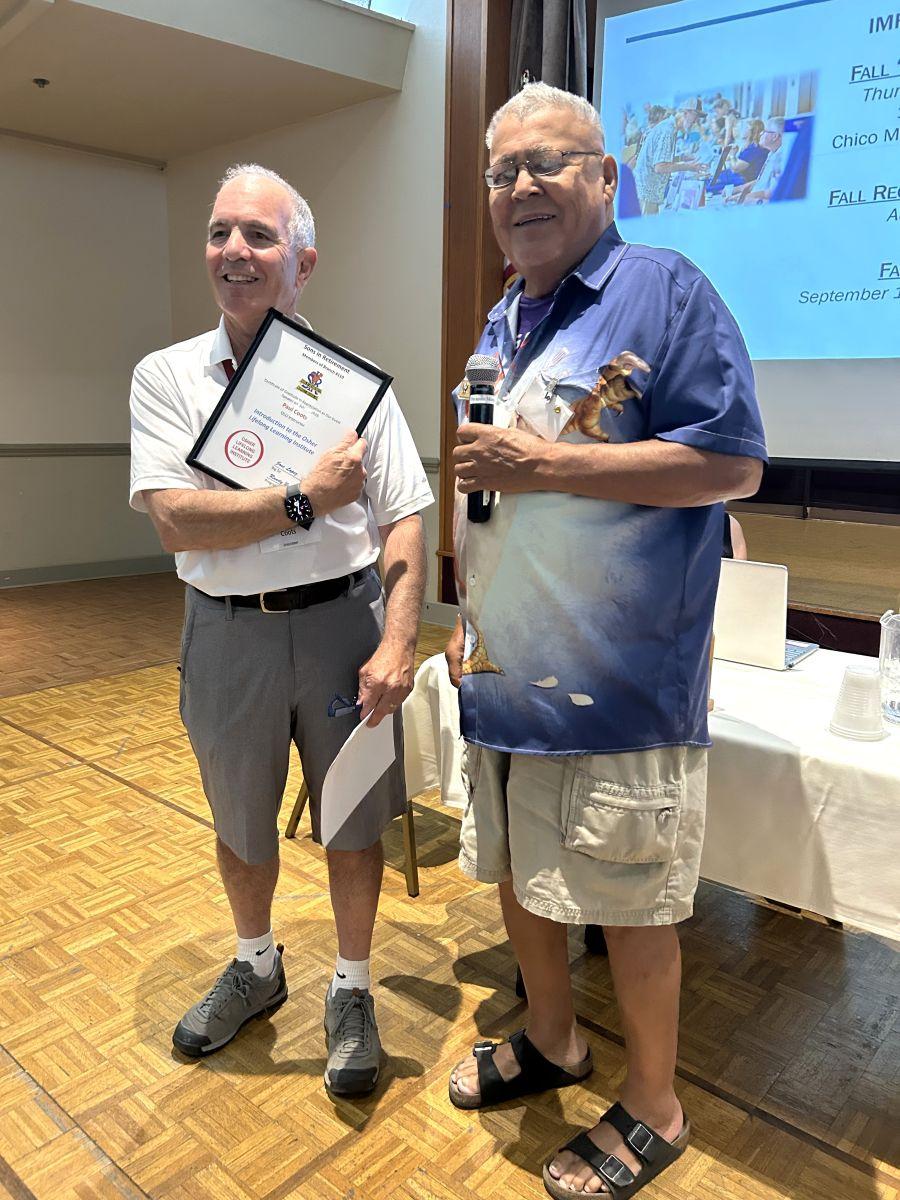 Paul Coots receiving a plaque from Jose Lopez at SIR