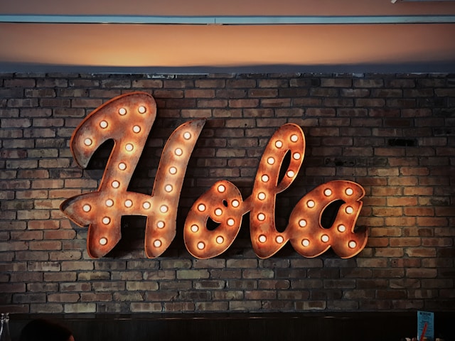 a lighted sign saying Hola