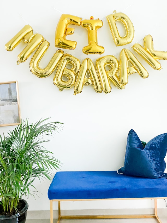 gold balloons spelling out Eid Mubarak