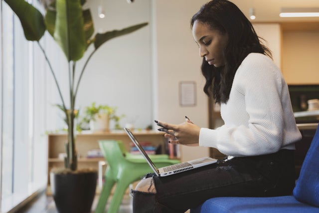 A Black woman with a laptop