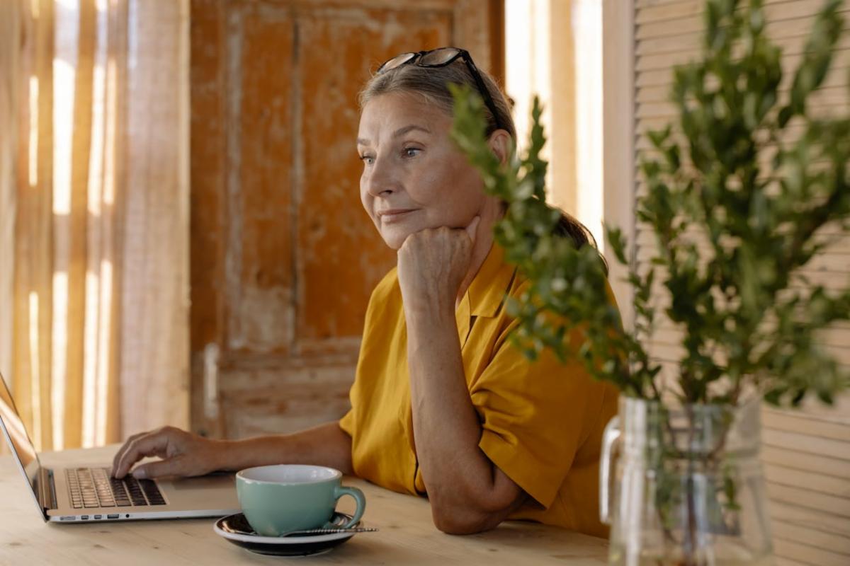An older woman on a laptop.