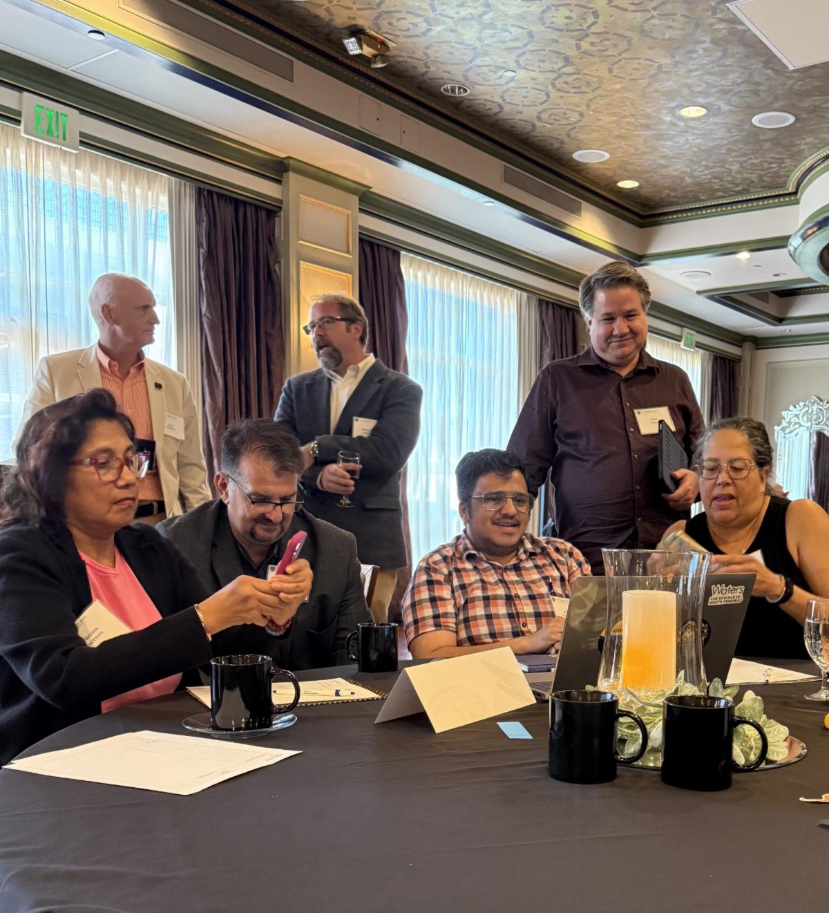 Image of Anoop Arunagiri presenting at his table to several participants
