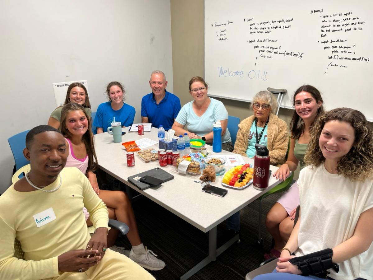 undergraduate students exploring adult development and aging engage in group discussions with OLLI members