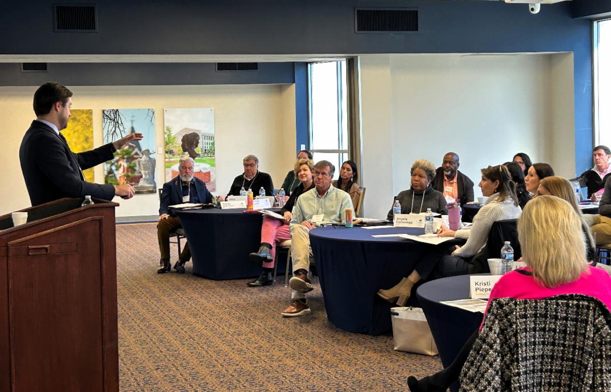 an instructor having a discussion with a group of workshop participants.