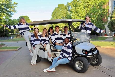 The Campus Kitchen at AU team posing on a golf cart