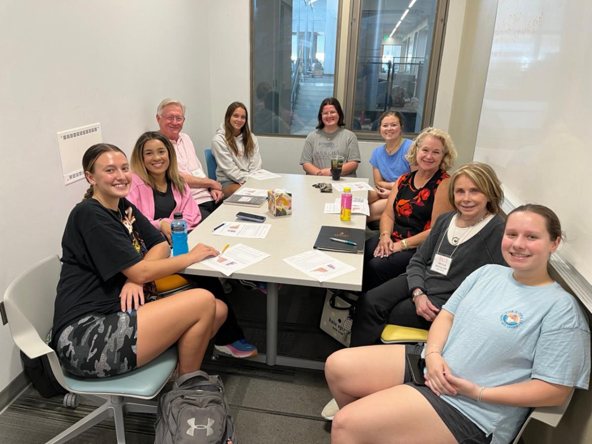undergraduate students exploring adult development and aging engage in group discussions with OLLI members