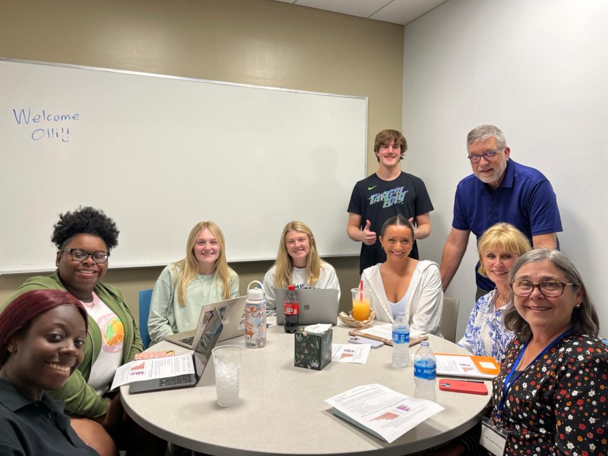 undergraduate students exploring adult development and aging engage in group discussions with OLLI members