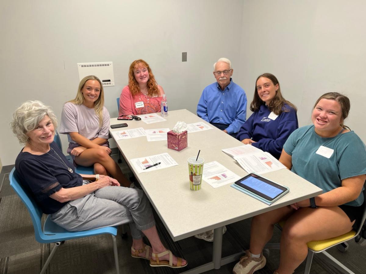 undergraduate students exploring adult development and aging engage in group discussions with OLLI members