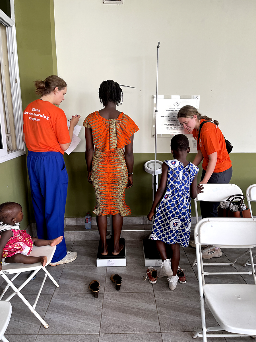 Students providing service and working with local clients in Ghana- Anne and Eliza