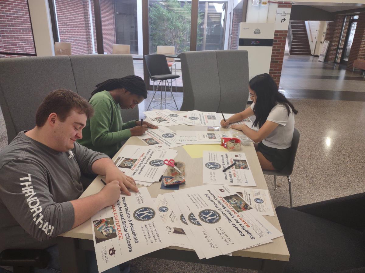 Circle K International students at Auburn University prepare posters and flyers for the senior supply drive.