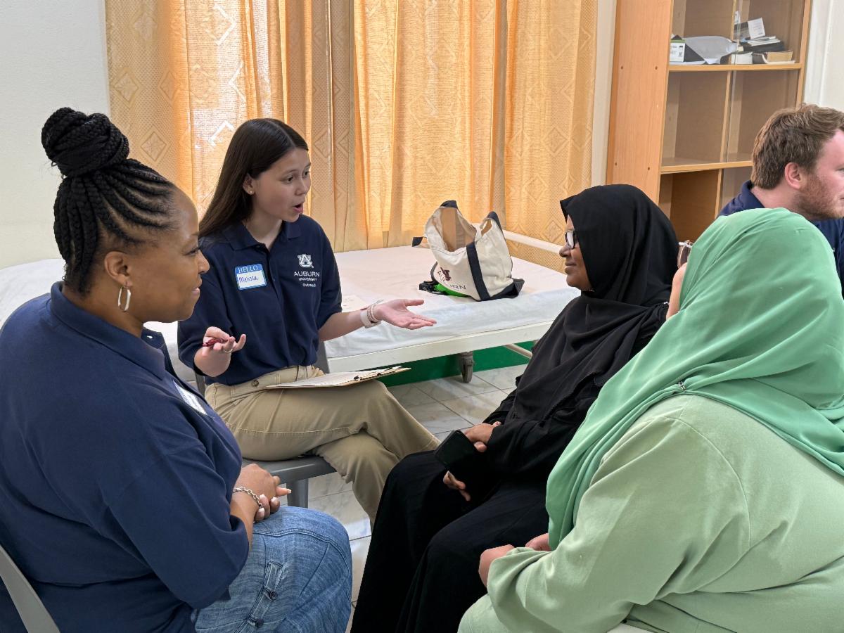 Dr. Chippewa Thomas, Mellisa Sanders counseling some Maldivians citizens during the service-learning program at Fenfushi health clinic center.