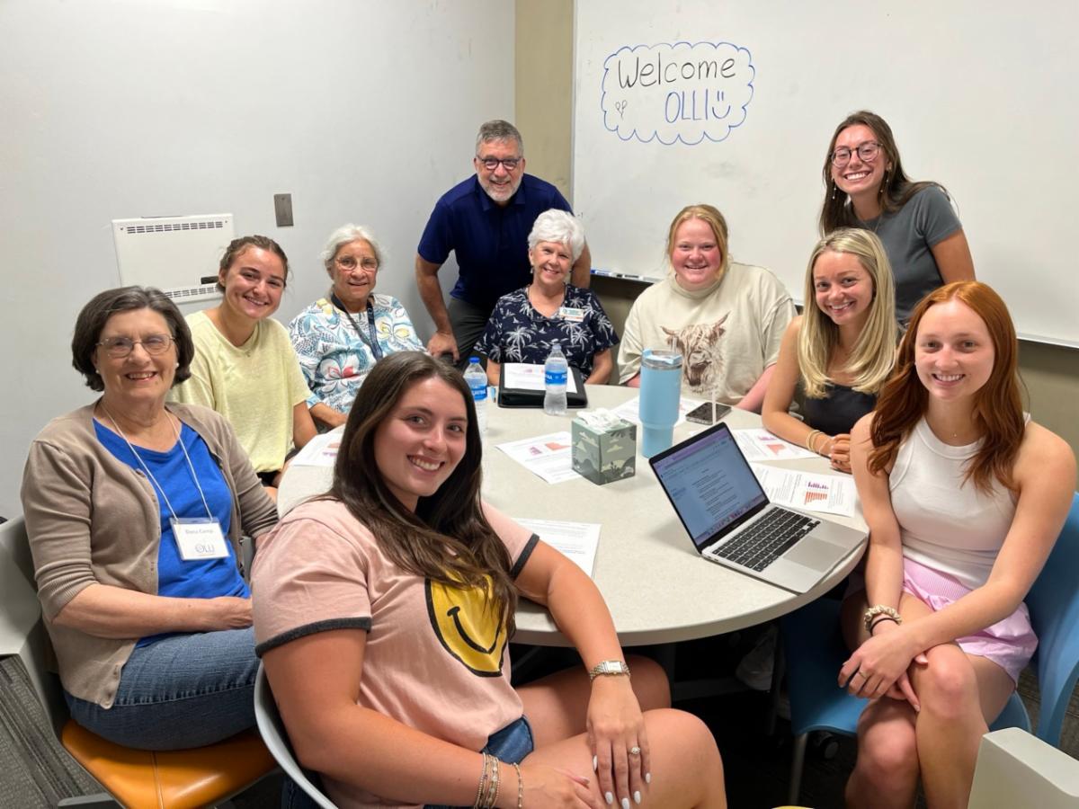 undergraduate students exploring adult development and aging engage in group discussions with OLLI members
