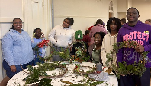 Decetti Taylor, left, and her sister-in-law, Emily Boyd, seated, are just two parents that regularly attend Auburn Outreach’s Young Professionals in Training program because of the benefits to their children and themselves.