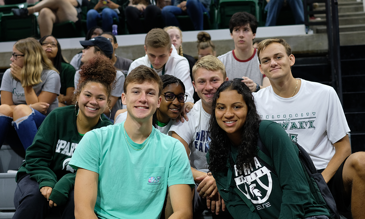 Group of Spartans smile together at an event in Breslin.