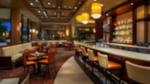 Blurred background of an elegant bar interior showcasing the upscale design of a restaurant_ featuring warm lighting and inviting seating arrangements for a chic atmosphere.
