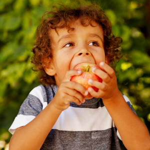Photo of a child eating an apple