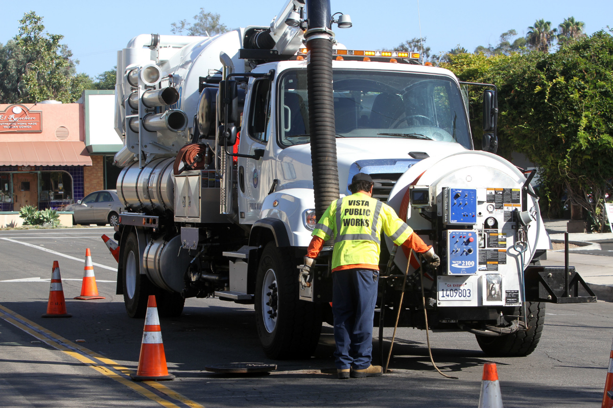 Photo of a Public Works employee and vehicle