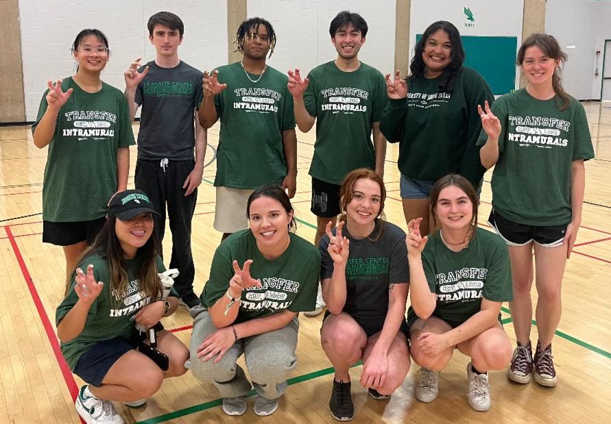 Group of Students wearing Transfer Intramural shirts and showing the UNT Eagle Claw hand sign
