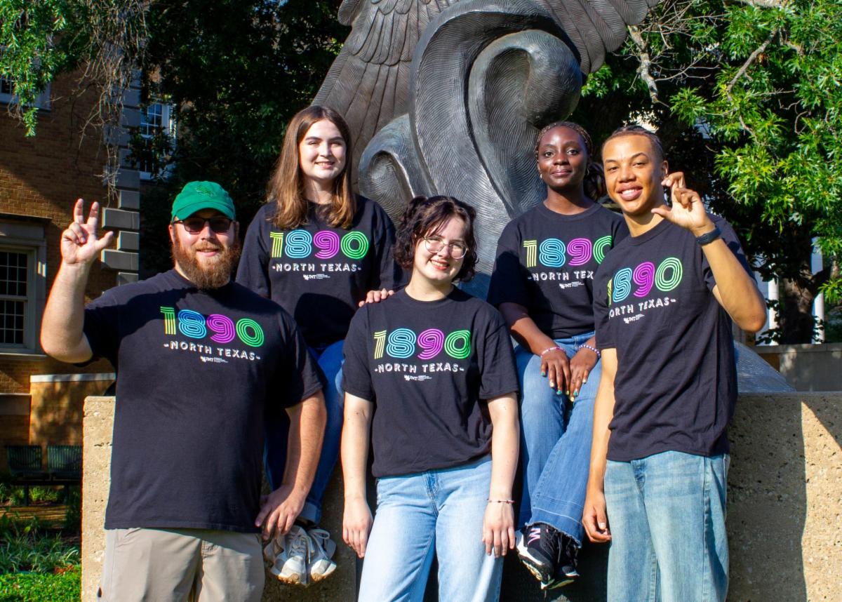Group of UNT students smiling on campus