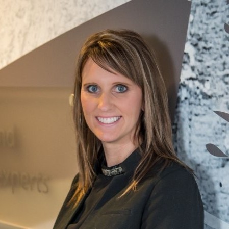 Headshot of woman leaning agains a wall