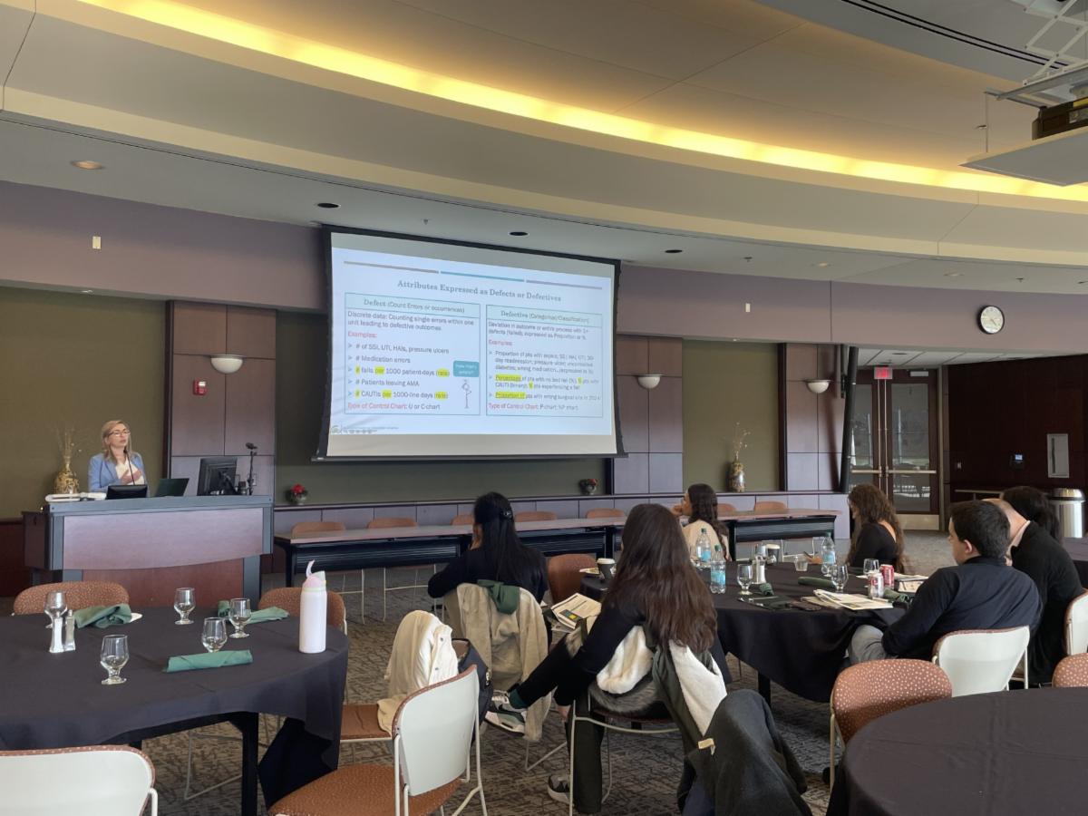 Attendees watching a PowerPoint presentation