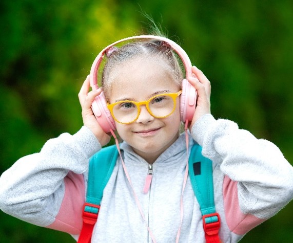 A child wearing headphones and smiling
