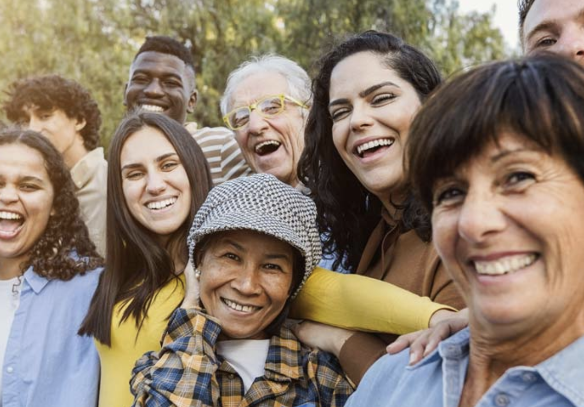 A diverse group of people smiling at the camera.