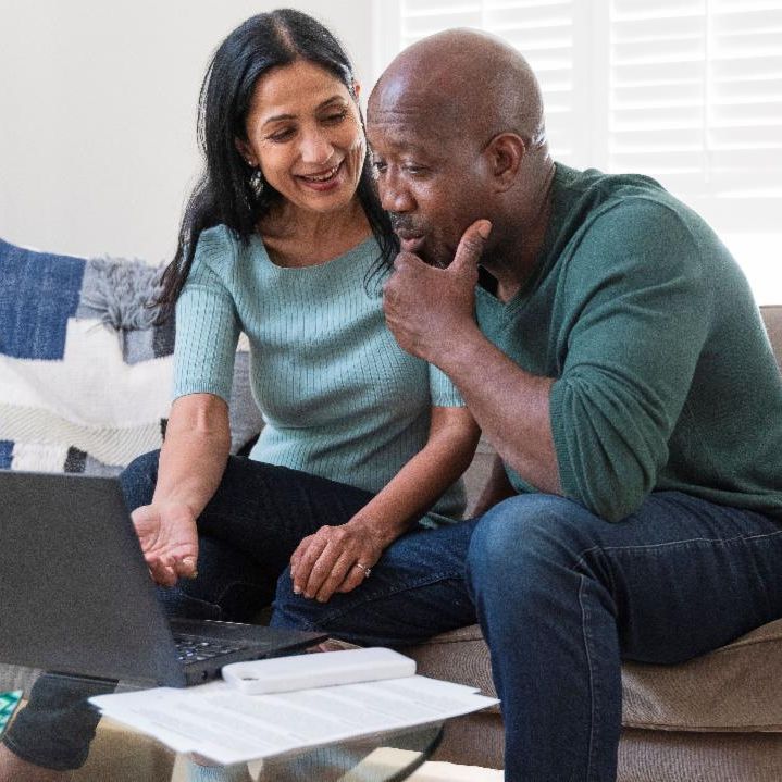 A couple looking at a computer.