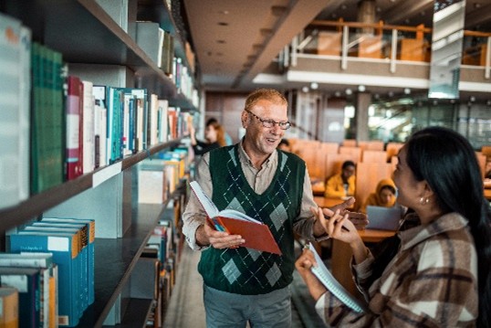 Man and woman conversing in library