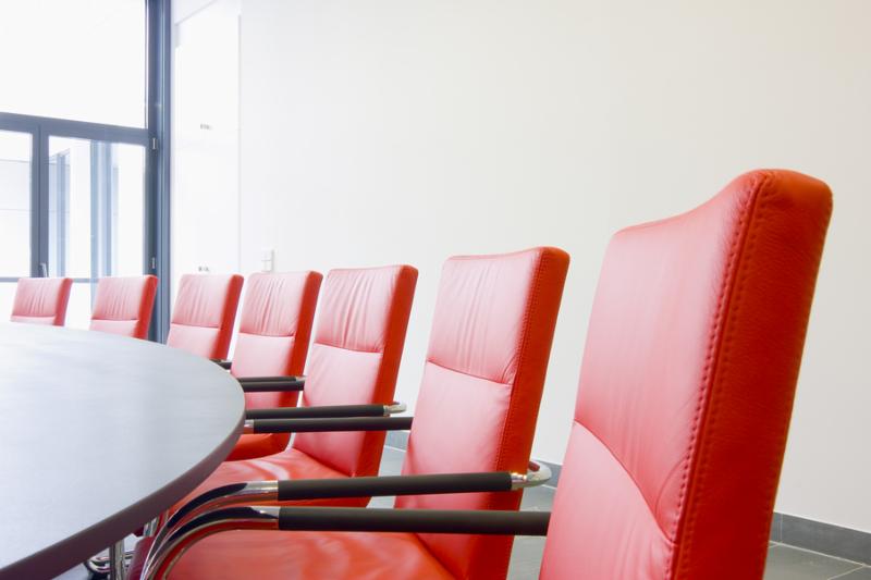 Red leather chairs in a conference room