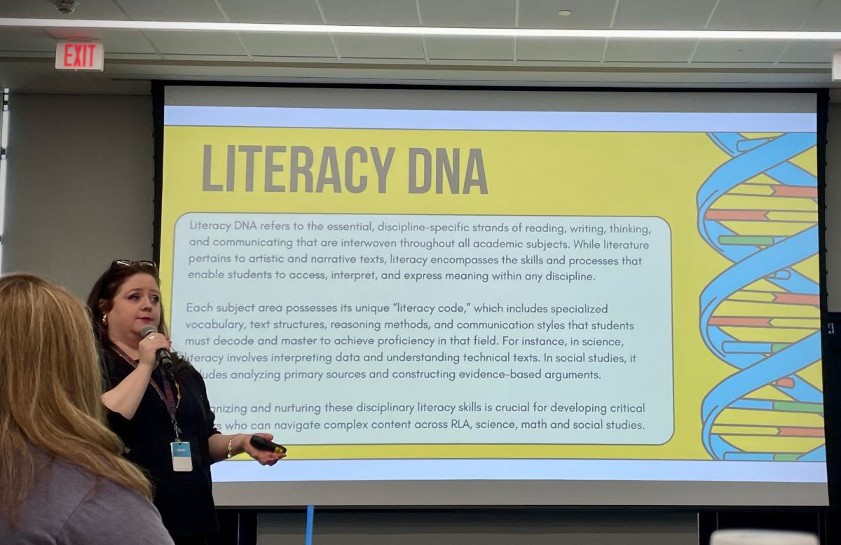 photo of Tomball ISD presenter in front of a Literacy DNA image