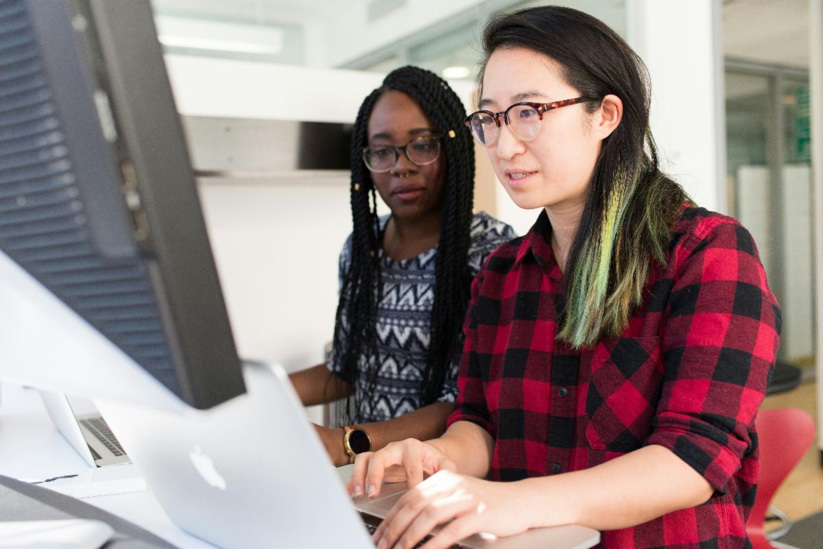 two teachers collaborating at a computer