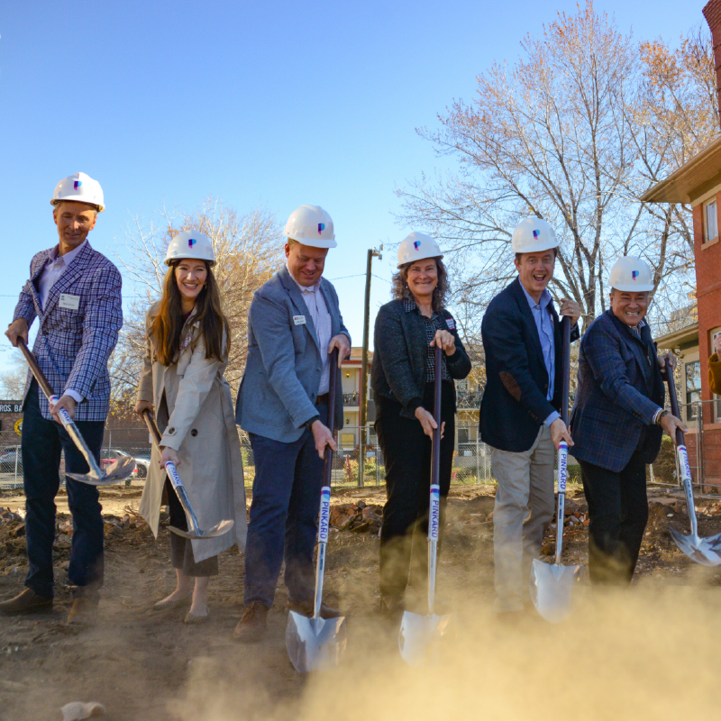 A group of six people with shovels at a groundbreaking