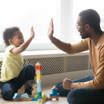 A man and a boy high fiving