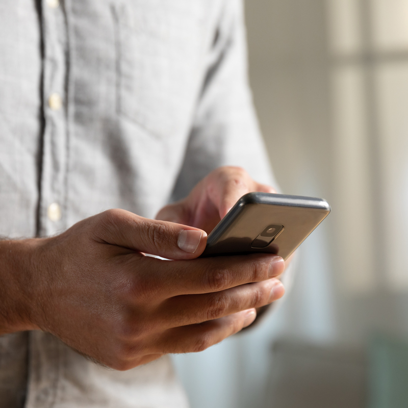 a close up of hands typing on a phone