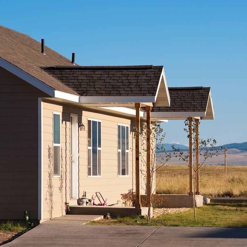 The porch of an attached home in a rural area