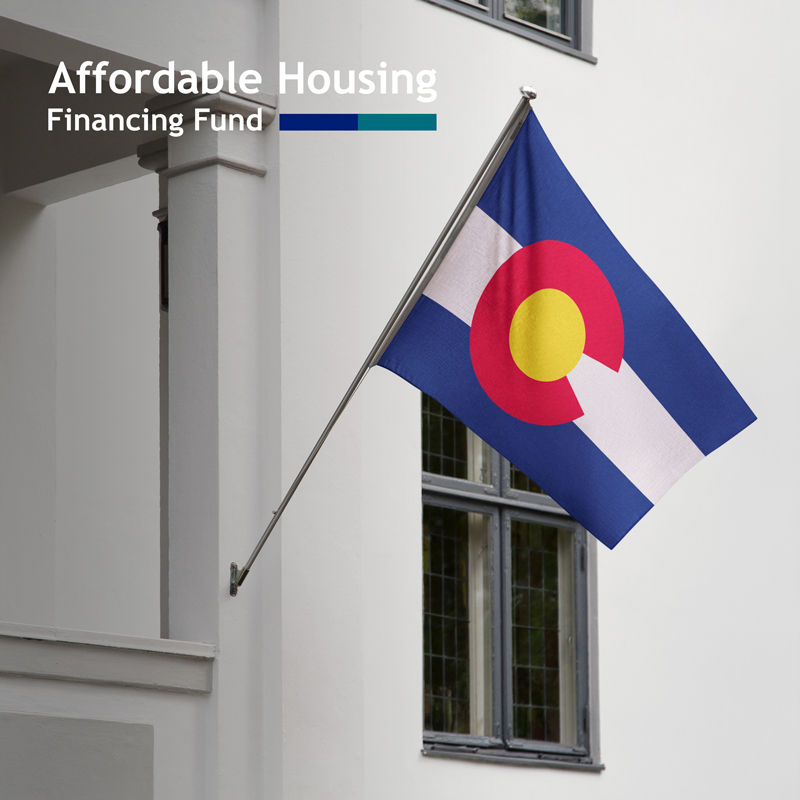 a colorado flag on a white building with the affordable housing financing fund logo.