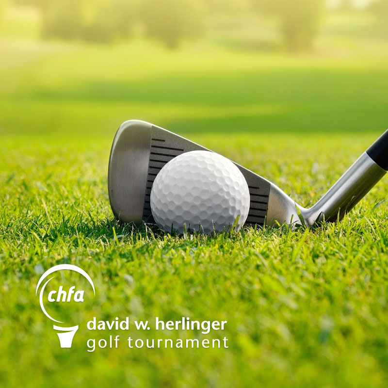 A golf club and golf ball with CHFA golf tournament logo