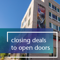 text that reads closing deals to open doors over a multifamily building and blue sky