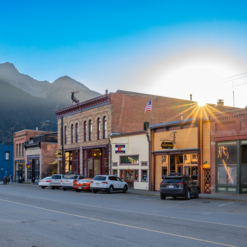 Sunrise behind mainstreet storefronts